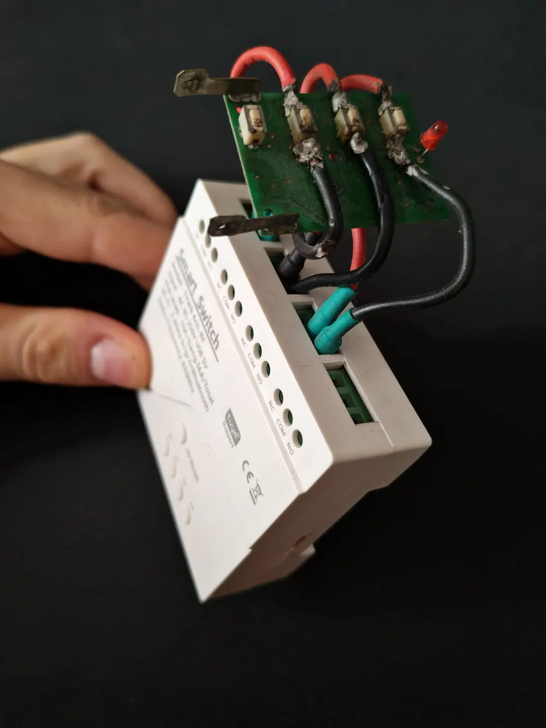 Side view of the garage door remote's board wired to the Smart Switch Module